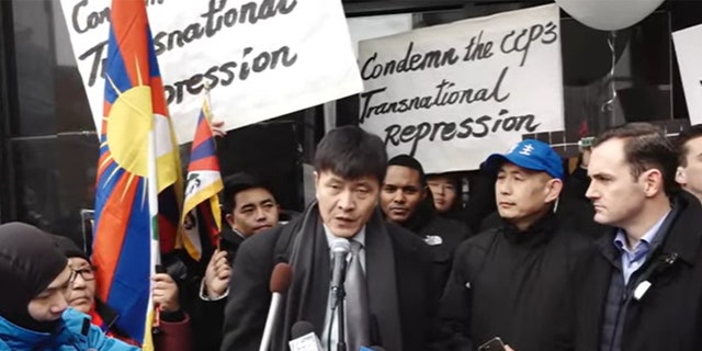 Chinese civil rights activist Zhou Fengsuo speaks at the press event held outside a recently raided Manhattan
