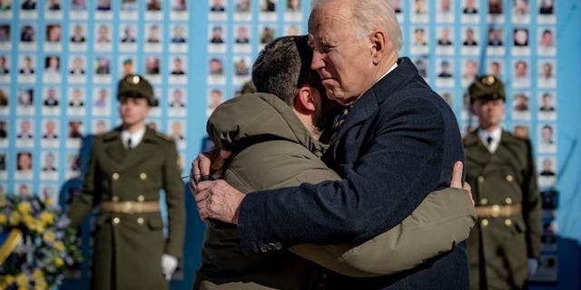 President Joe Biden, right, and Ukrainian President Volodymyr Zelenskyy hug as they say goodbye at the Memorial Wall of Fallen Defenders of Ukraine