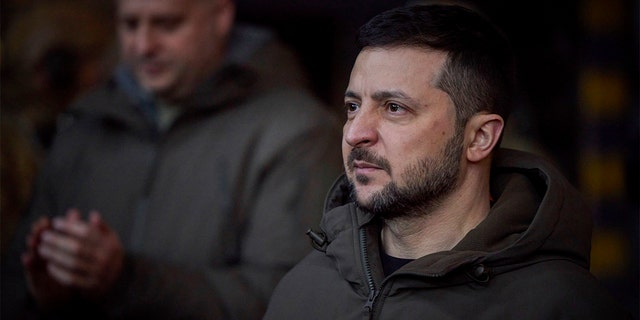 In this photo provided by the Ukrainian Presidential Press Office, Ukrainian President Volodymyr Zelenskyy, looks on as he meets soldiers at the site of the heaviest battles with the Russian invaders in Bakhmut, Ukraine, Tuesday, Dec. 20, 2022.